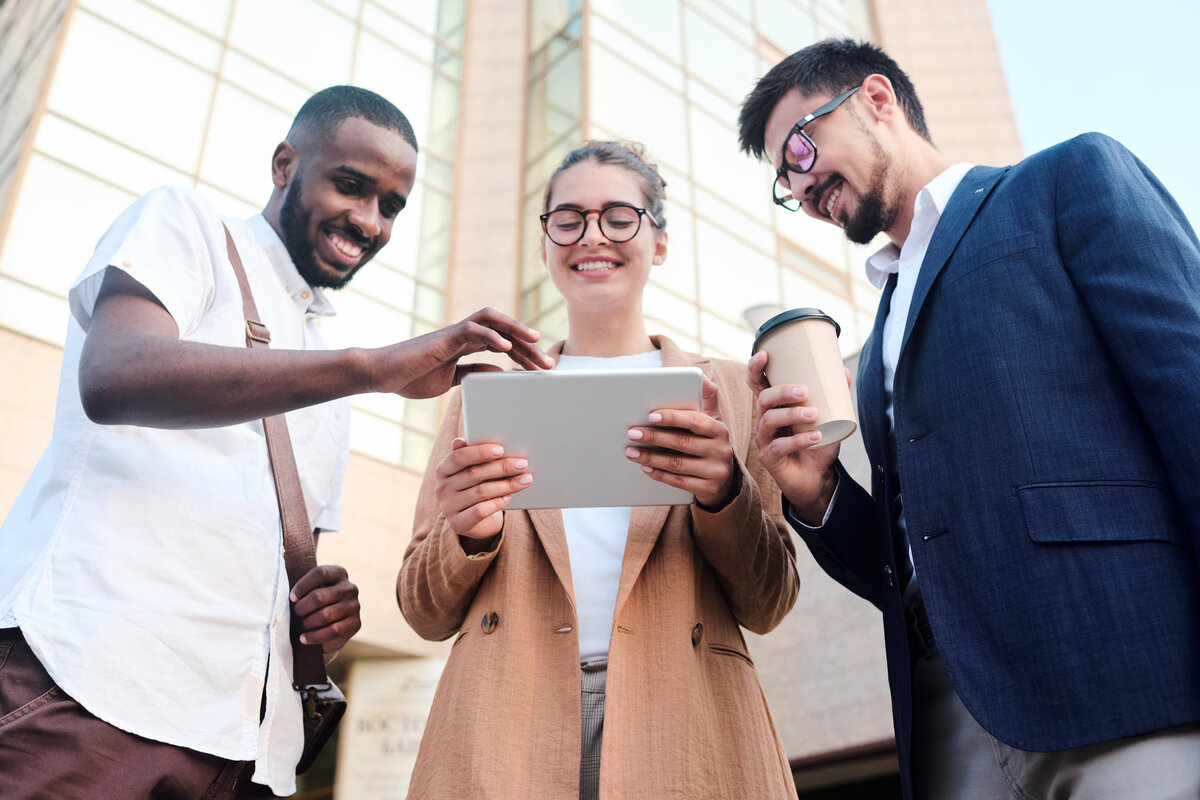 Three business people looking at a tablet computer.