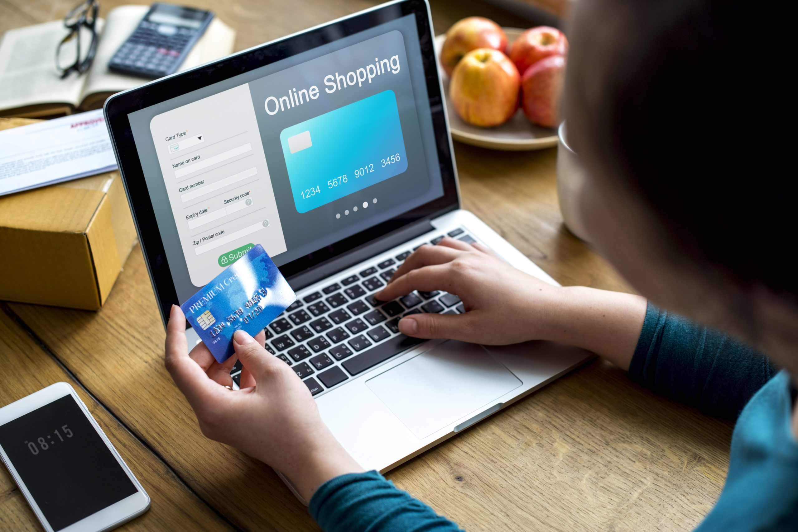 A woman is making an e-commerce purchase using a laptop.