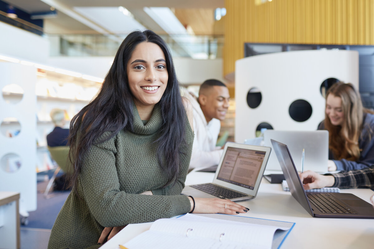 University students using laptops and digital tablet, working together for SEO